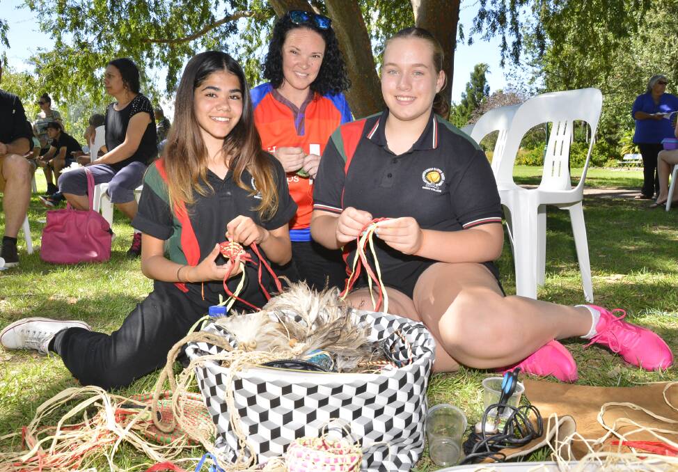 TIGHTLY WOVEN COMMUNITY: Dubbo College South students Talesha Murray and Gemma Ryan practice their coiling technique with Weaving Dreams' Jaime Murray at the Healing Day. Photo: BELINDA SOOLE