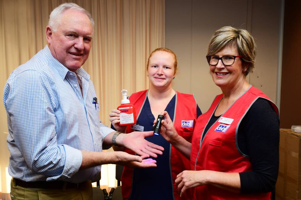 HAND HYGIENE: Parliamentary Secretary for Western NSW Rick Colless gets ready for a hand hygiene lesson from the Western NSW Local Health District's Sandra Wharton with help from Dubbo Hospital's Steph Sellings (centre) . Photo: BELINDA SOOLE