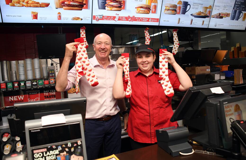 SMILES: Dubbo West McDonalds licensee Gary Barraclough and employee Emma-Rose Moran getting ready for McHappy Day. Photo: BELINDA SOOLE