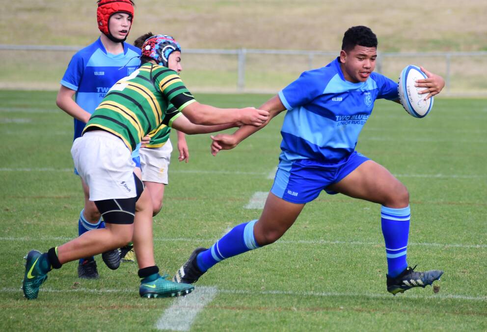POWER: Two Blues prop Hasani Bloomfield looks to escape an attempted tackle. Photo: BELINDA SOOLE