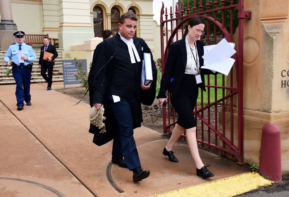 Trial opens: Crown prosecutor Mark Davies (front left) leaves Dubbo Courthouse after making his opening submissions. 