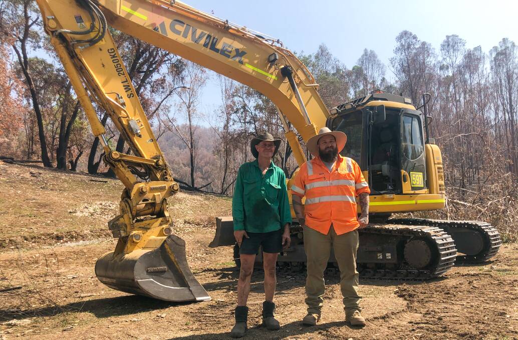 Cattle farmer Barney Pollard with Civilex excavator operator, Michael Humphreys. The fire started at the back of Mr Pollard's property. 