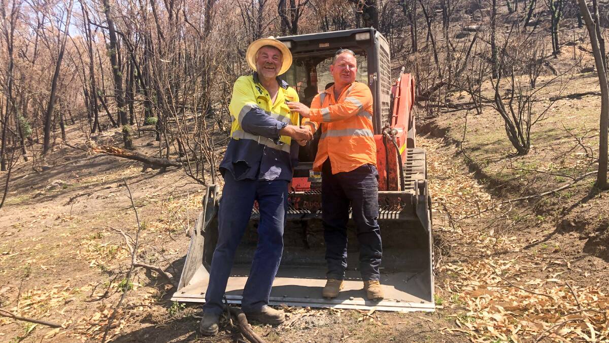 Landholder Andrew 'Curl' Jeffries with Civilex operator Grigor Driscoll. Mr Driscoll was using a posi-track to clear tracks. 