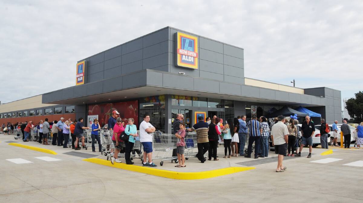 New look: Shoppers lined up nice and early for Dubbo's new ALDI store, which opened in September 2014. Photos: BELINDA SOOLE. 