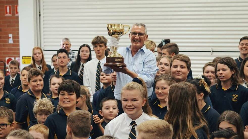 Special visit: Melbourne Cup-winning jockey Greg Hall with the trophy at Yeoval Public School. Photo: Supplied. 