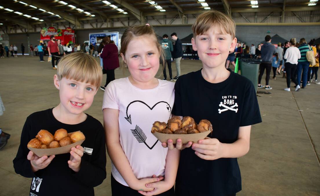 FOOD LOVERS: Darcy, Piper and Jayden Hocking enjoyed delicious filled donuts at the Foodies Markets in July. Photo: AMY McINTYRE. 