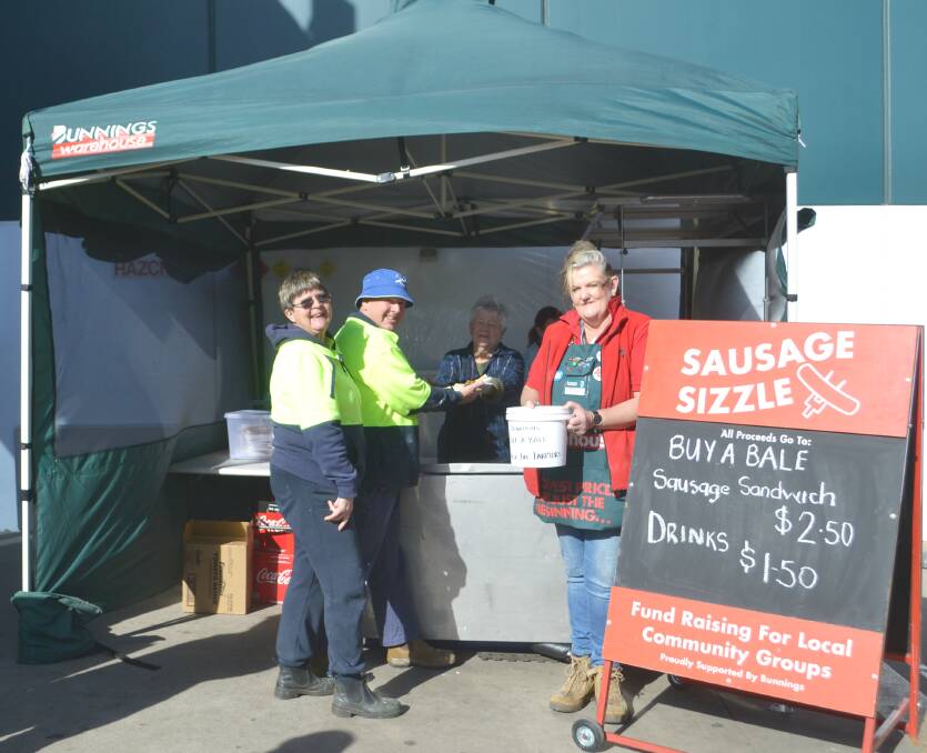 Barbecue for farmers: Bunnings members Corrine Webb, Nancy Pemble and Kelly Hinch-Cliffe with customers Glenys and Peter Rendell. Photo: Taylor Jurd. 