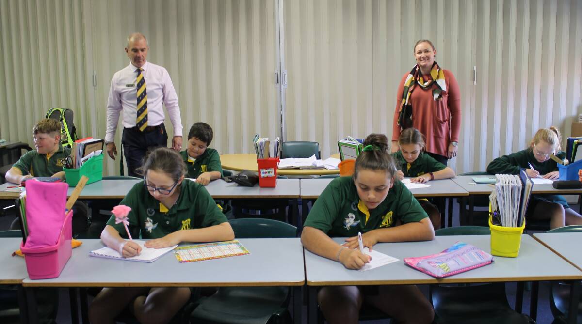 Back to school: Dubbo North Public School Stage 3 students working in the classroom with teacher Mrs Wallace and principal Mr Morgan. Photo: Supplied. 