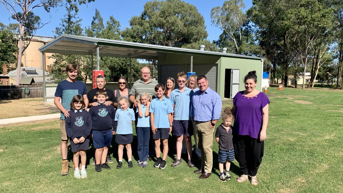 Dubbo MP Dugald Saunders with Geurie Public School students, staff and members of the community in front of the new, sheltered play area. Photo: Supplied. 