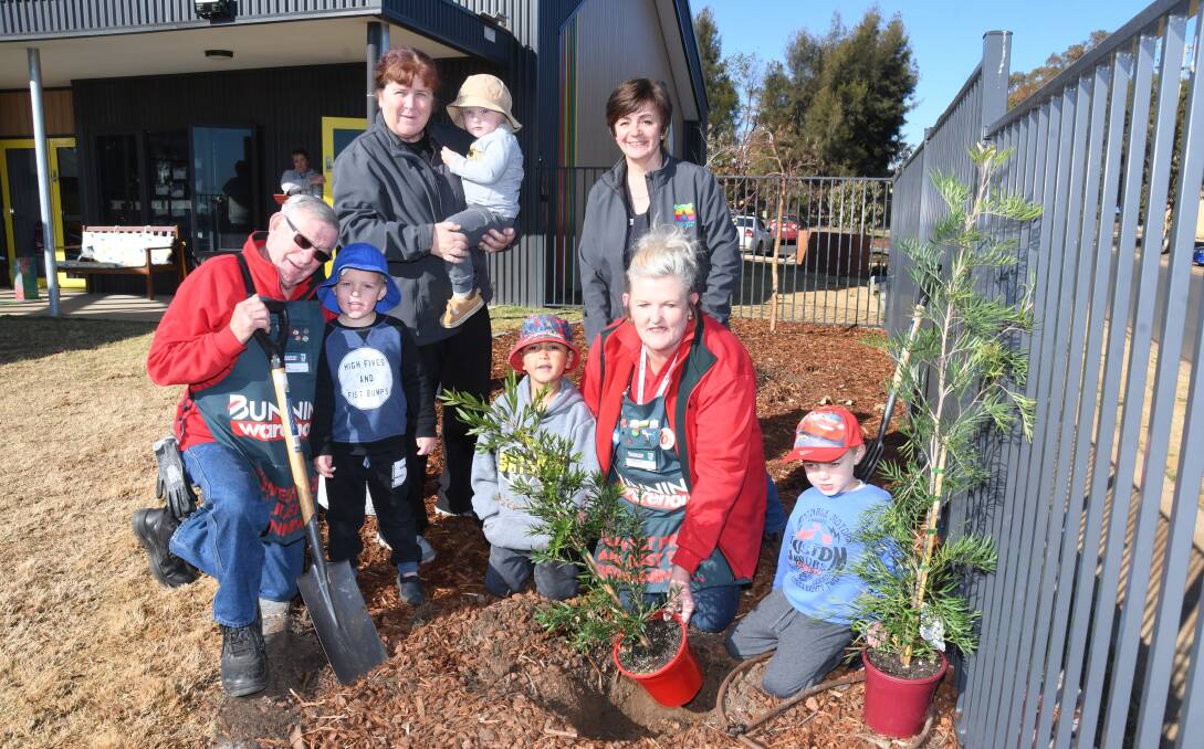 Enviro Care: Dubbo Bunnings staff Neil Rabbett and Corinne Webb with Christine Castlehouse and Mariana Smithers from Playmates Cottage helped students Jackson York, Levi Bamblett and Malleek Riley plant trees for National Tree Day. Photo: Belinda Soole. 