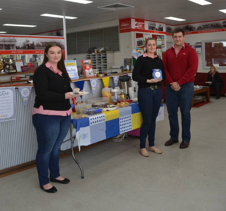 Raising funds: Dubbo Elders Rural Services staff Kehanni Adams, Lyndy Peters and Will Chaffey take part in Australia's Biggest Morning Tea. Photo: Taylor Jurd. 