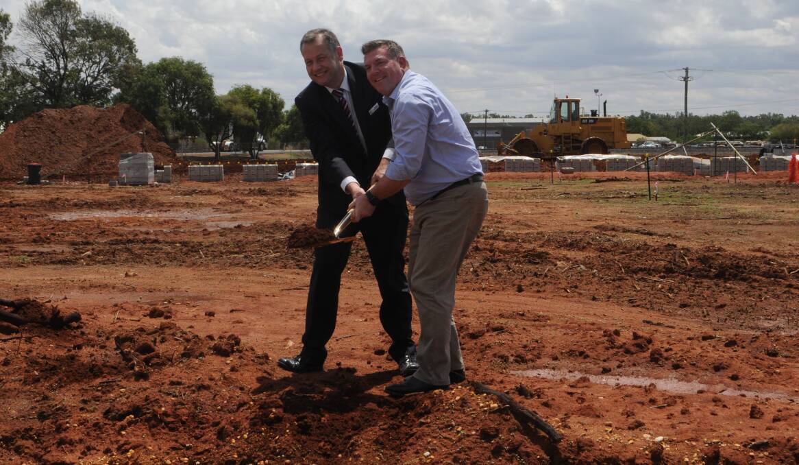 Sod turning: Dubbo Regional Council mayor Ben Shields and Dubbo MP Dugald Saunders turn the first sod at the construction of the new wash bay at the saleyards. Photo: Taylor Jurd. 