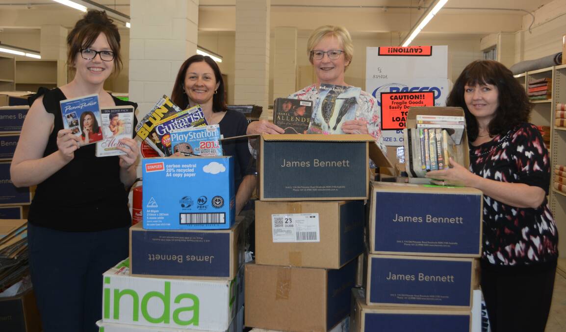 Book lovers dream: Macquarie Regional Library's Sarah Tilbrook, Jodie Saville, Lindy Allan and Helen Thompson, with some items for the sale. Photo: Taylor Jurd.  
