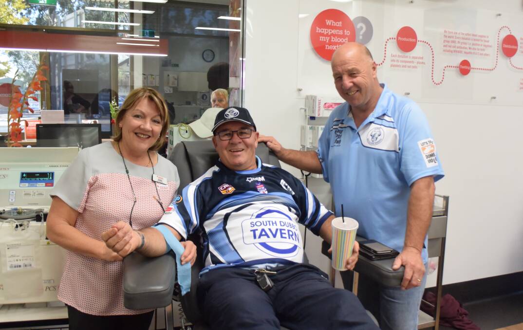 Bleed blue: Dubbo blood donor centre manager Debbie Garden with Macquarie Raiders Club treasurer Ray Sutcliffe and president Ross McDermott. Photo: Taylor Jurd.