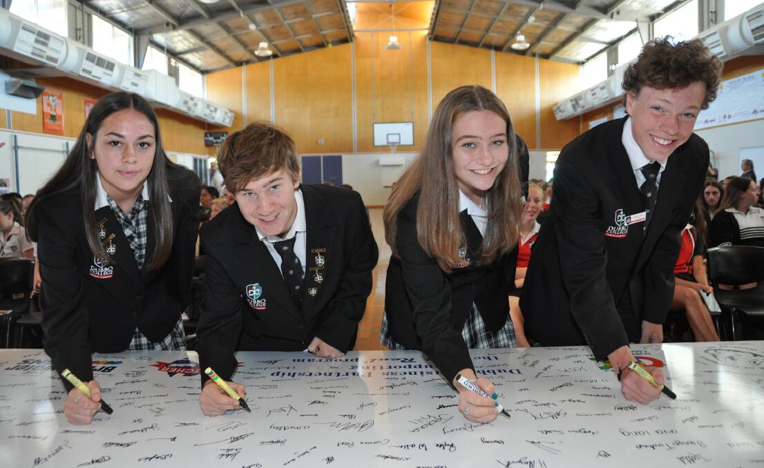 Dubbo College junior campus captains Kady Lake, Bayleigh Wellington, Sorelle Thomas and Jonathan Gleeson sign the 2019 Get Real pledge board. Photo: Supplied.