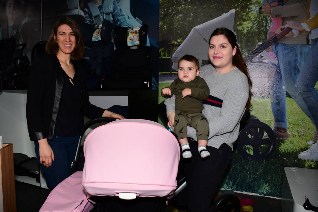 A helping hand: Royal Bubs and Tots owner Larissa Kek discusses prams with Bri Cook and Aref, 11 months at the Baby Expo. Photo: Amy McIntryre.