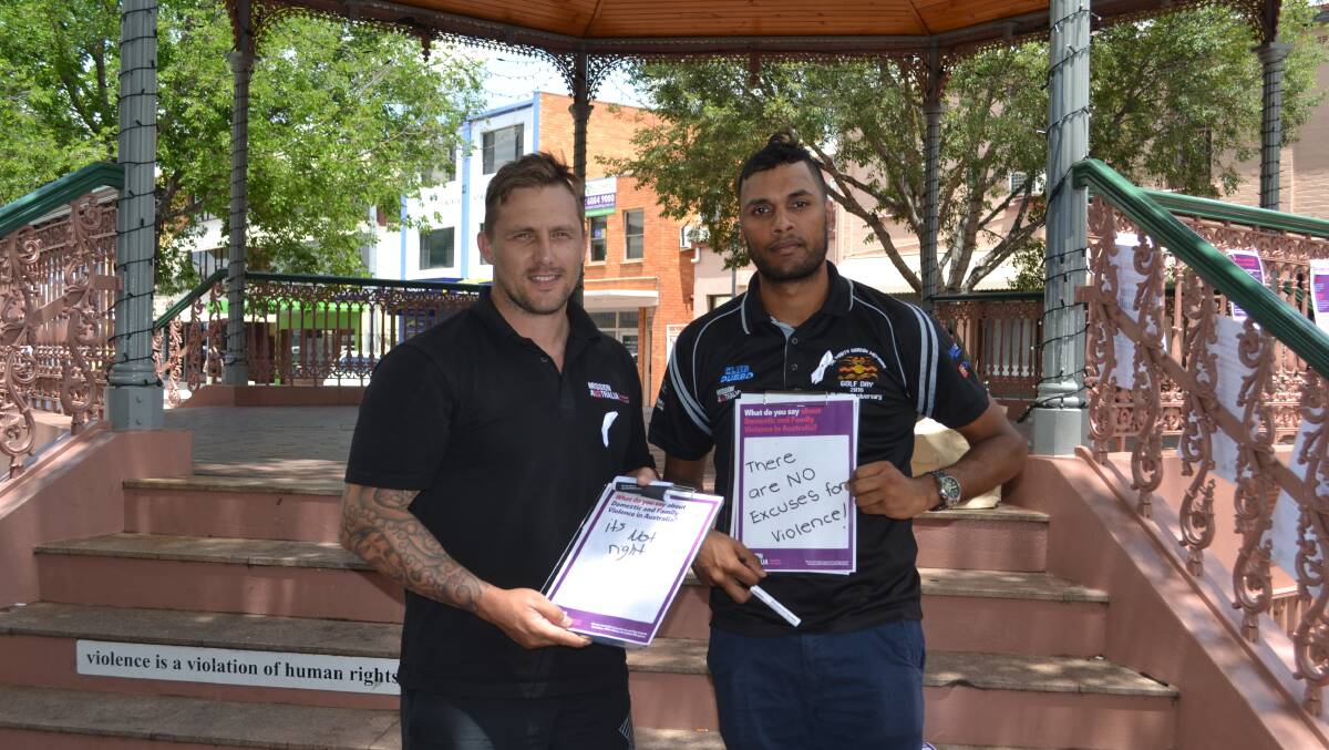 Break the silence: Dubbo's Rob Hayward and Ray Fuller from Mission Australia last year signed the White Ribbon Day pledge to speak up about domestic violence. Photo: Taylor Jurd. 
