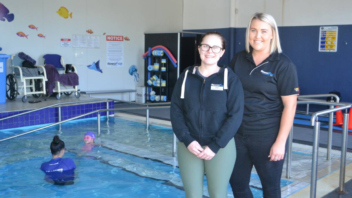 Learning: Fitness Focus swimming school co-ordinator Emma Murphy, with instructors Sophie Brabrook and Teisha Toomey with Isla Darcy in the pool. Photo: Taylor Jurd.  