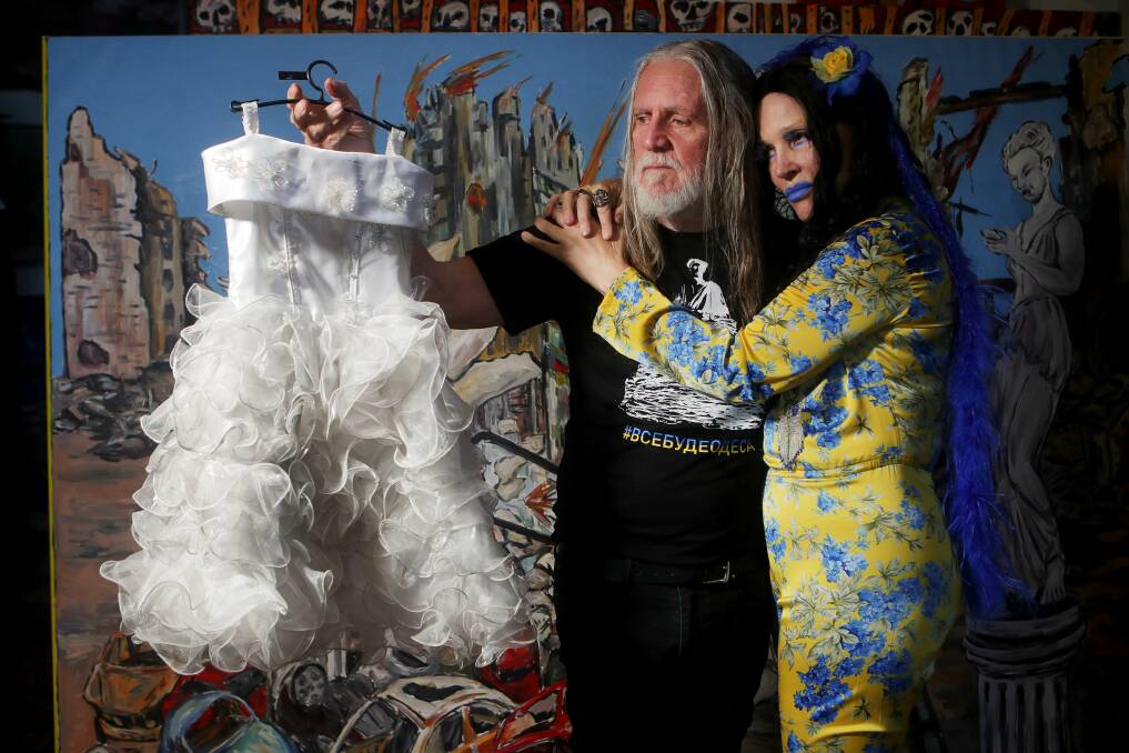 George Gittoes and Hellen Rose with a child's dress they found eerily blowing in the wind in Borodyanka. They say many families tried to show there were children around in the hope their home or neighbourhood would not be bombed, but the efforts were in vain. Picture: Sylvia Liber