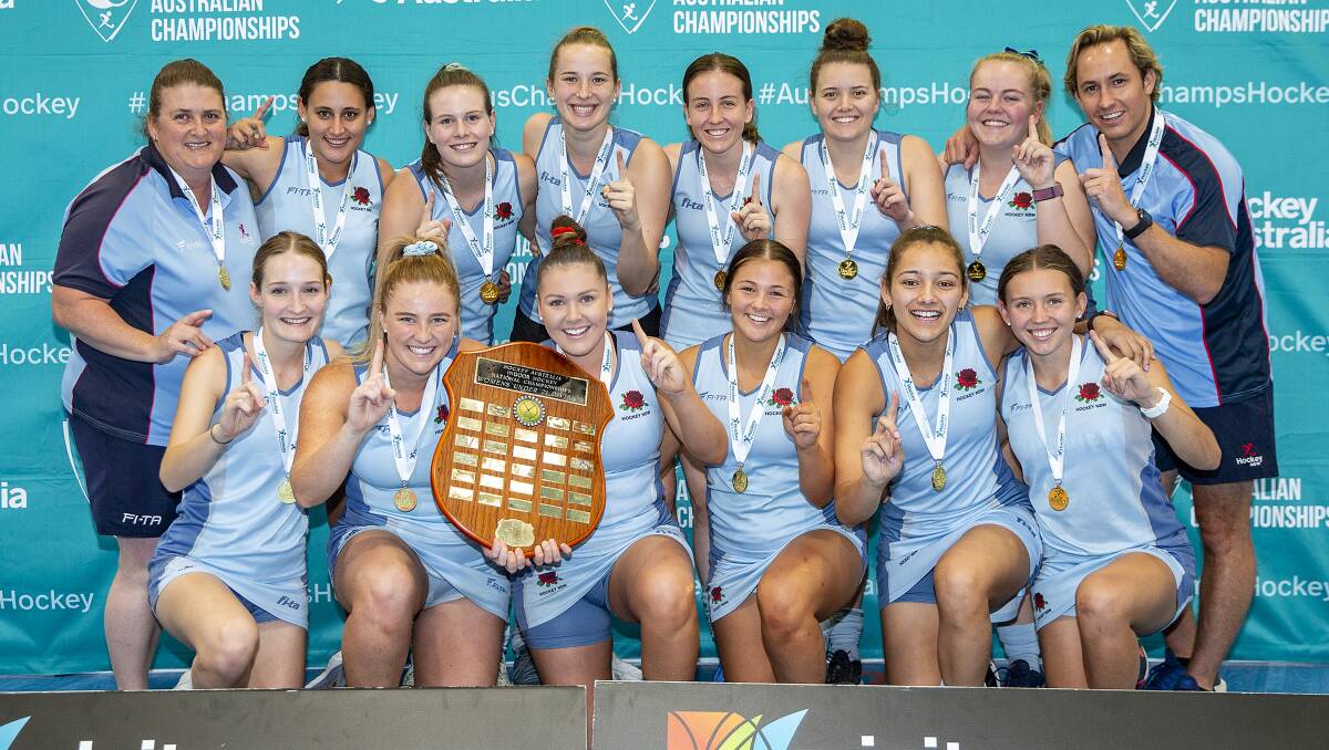 NUMBER ONE: Emma Corcoran (front, third from left) holds the shield up with co-captain Chloe Barrett after NSW's 7-2 victory in the under 21s final. Photo: CLICK IN FOCUS. 