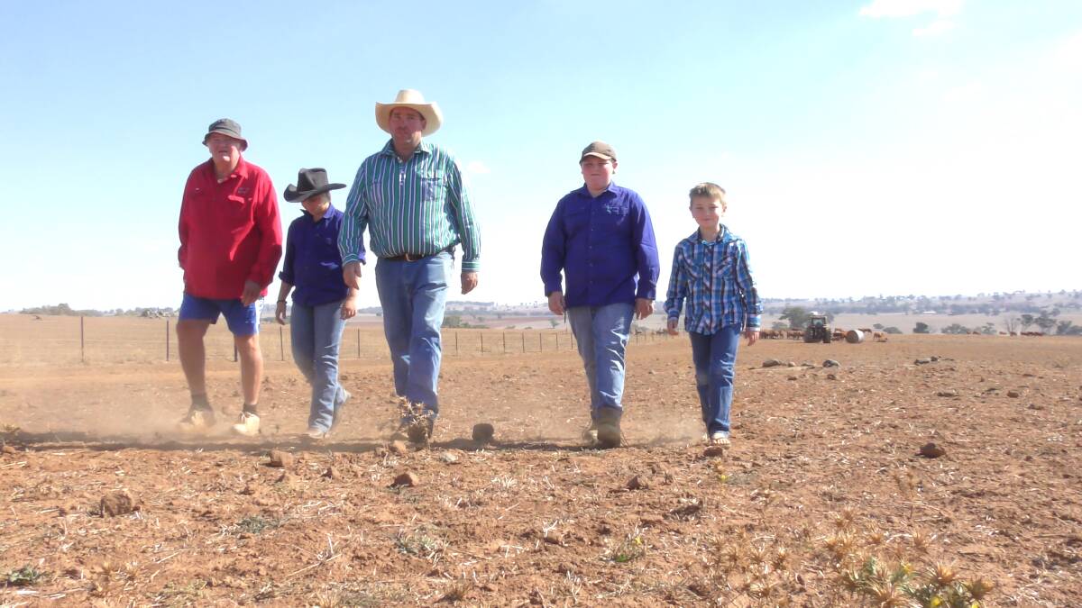 John, Brooke, Chris, Thomas and Jack Haycock trudge through the dust of their property at Yeoval. Photo: SUPPLIED. 