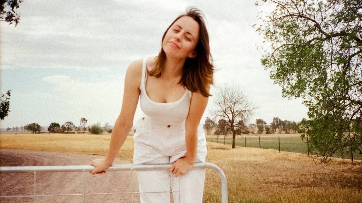 IN HER OWN SKIN: Sophie Payten - known on stage as Gordi - swinging on the front gate of her family's property in Canowindra. Her album Our Two Skins is out next Friday. Photo: SUPPLIED