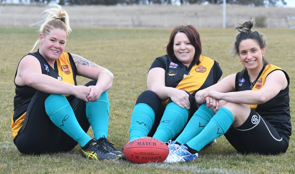 SISTERS IN ARMS: Cat Lee, Renee Cullis and Kristen Hunter all played alongside Katrina Hobby in the Tigerettes' first season in 2015 and will remember their friend this weekend. Photo: JUDE KEOGH 