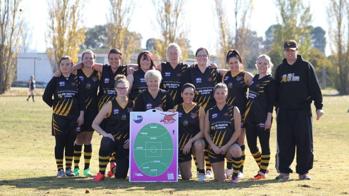 TIGERETTES' FIRST WIN: The post-game shot of the Tigerette's first ever win, in 2015 over Cowra. In the photo from back left is Jade Charnock, Leticia Tremain, Katrina Hobby, Renee Cullis, Jess Bond, Kristy Mansell, Kristen Hunter, Sam Tisdell, Matt Tabbernor (coach), and front, from left Meg Englart, Jlie Dittmar, Jayarna Kay, Teresa Costello won their first game of 2015 last weekend. Photo: CONTRIBUTED
