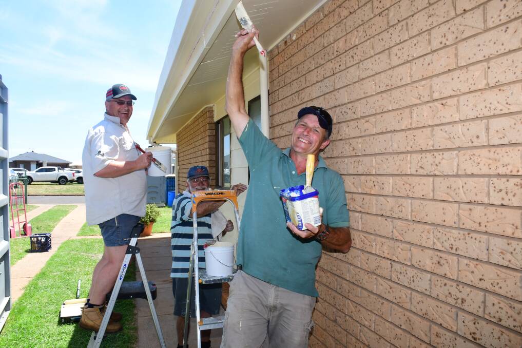 WORKING BEE: Rotary Club of Dubbo South's David Duffy, Joe Canalese and president David Parish help make over the Ray family's West Dubbo home at the weekend. Photo: AMY MCINTYRE
