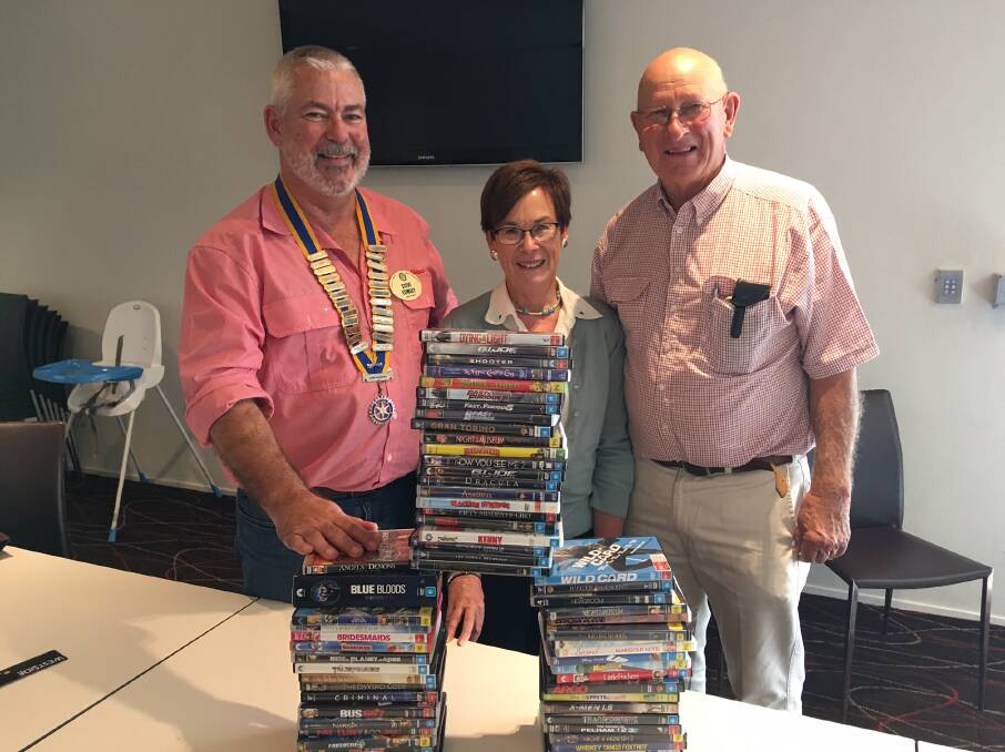 TRYING SOMETHING NEW: Rotary Club of Dubbo Macquarie president Steve Cowley, Sally Coddington and Allan Clarke inspect some of the DVDs donated to the Michael Egan Memorial Book Fair. Photo: Contributed