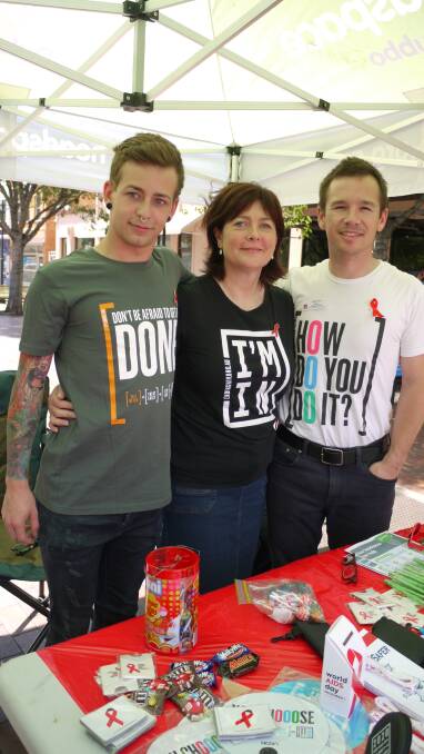 RAISING AWARENESS: Nic Steepe from headspace Dubbo and Margie Crowley and Clancy Barrett from Dubbo Sexual Health man the World AIDS Day stall at the Church Street rotunda on Friday. Photo: KIM BARTLEY