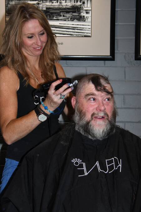 COMING OFF: Snip-Its hairdresser Kylie Harris shaves Paul Wasson's hair at the World's Greatest Shave at the Buncha Hotel in Dubbo on Saturday. Photo: AMY McINTYRE