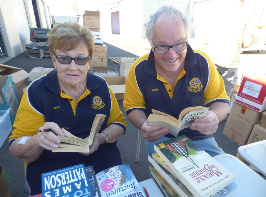 BOOK BREAK: Rotary Club of Dubbo Macquarie members Judy Jakins and Peter Stanford check out books donated by the public to the annual Michael Egan Memorial Book Fair. Photo: Contributed