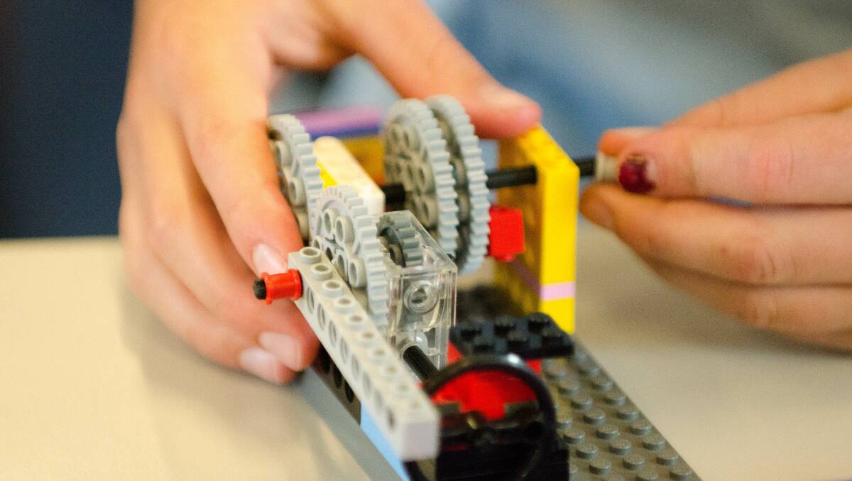 WORKSHOPS: A student explores the science of recycling and waste management by building a fully functional LEGO rubbish truck. Photo: CONTRIBUTED 