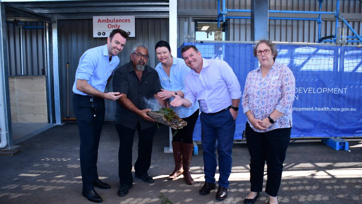 SMOKING CEREMONY: Dr Daniel Stewart, Lewis Burns, Margo Mackenzie, Dugald Saunders and Debbie Bickerton outside the new Emergency Department at Dubbo Hospital on Wednesday. 