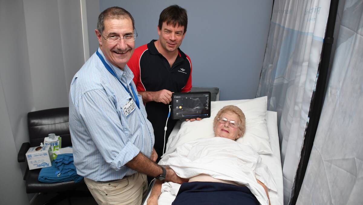 TRAINING: Chief medical officer for Royal Flying Doctor Service NSW Dr Randall Greenberg and Dr Peter Brendt use the new ultrasound equipment to scan volunteer Jean Brennan. Photo: BELINDA SOOLE