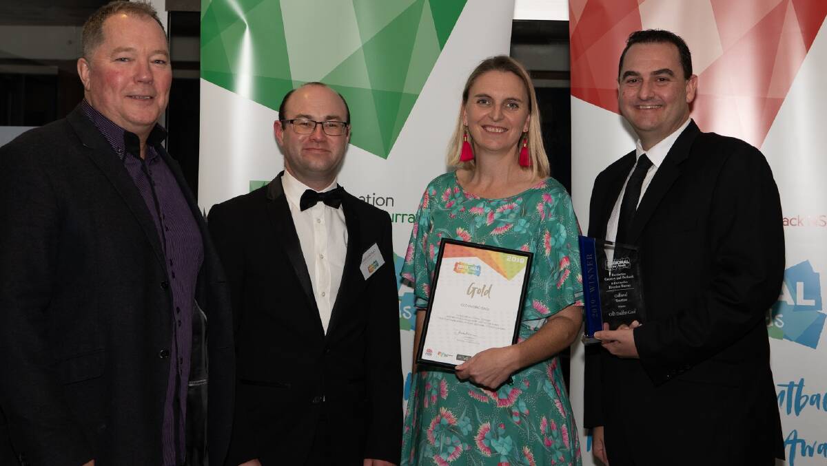 TOURISM AWARDS: Steve Timmis from Murray Regional Tourism congratulates Old Dubbo Gaol's Chris Anemaat, Kim Hague and Jamie Angus on winning gold. Photo: Contributed