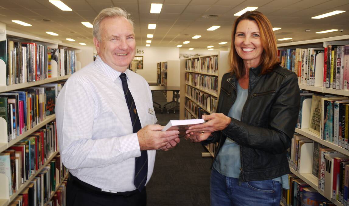 DEBUT NOVEL: Macquarie Regional Library director John Bayliss congratulates Toni Grant on her new novel, Serpent Song. Photo: KIM BARTLEY 