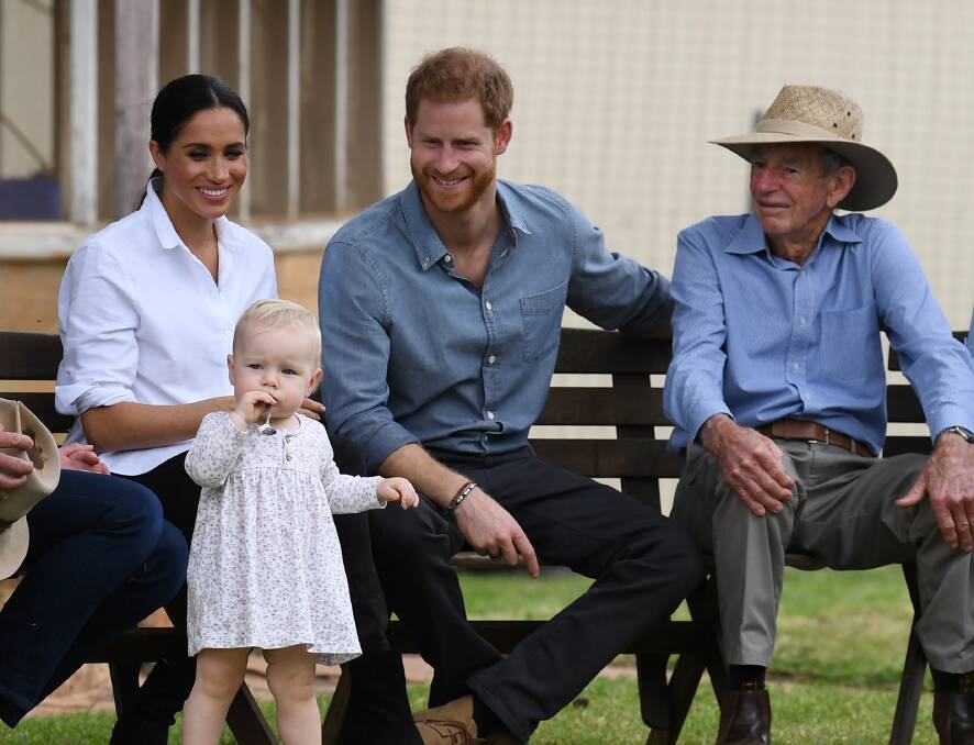 CUTE: The Duke and Duchess of Sussex, sitting next to Richard Woodley, appear besotted by his great granddaughter Ruby Carroll. Photo: DEAN LEWIS / AAP.