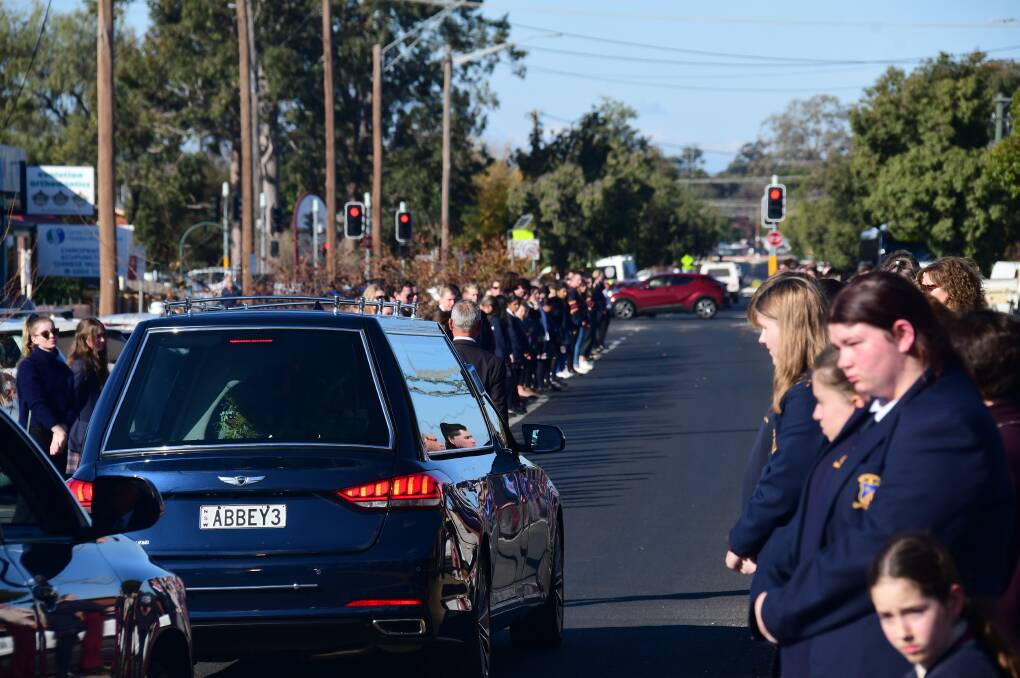 PAYING THEIR RESPECTS: Catholic school students and teachers farewell Diane Quade with a guard of honour after her funeral at St Brigid's Church on Friday. Photo: AMY MCINTYRE 