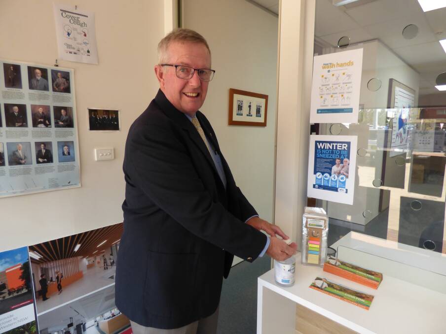 CLINIC: Regional Health Minister Mark Coulton, cleansing his hands at his Dubbo office on Tuesday, has announced a respiratory clinic for the city. Photo: KIM BARTLEY.