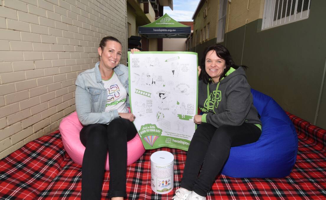 TIPS: headspace Dubbo's Marijka Brennan and Amy Mines hold a poster promoting  "seven tips for a healthy headspace". Photo: BELINDA SOOLE