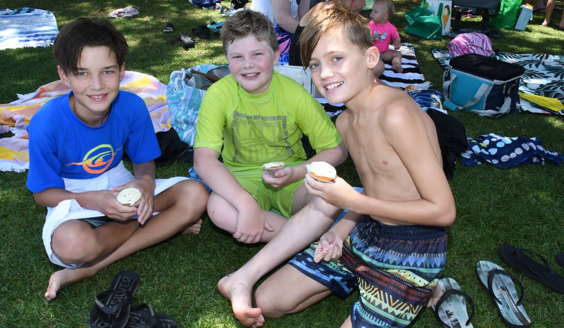 KEEPING COOL:  Ethan Warner, Will Emerton and Jack Warner enjoy cupcakes in the  shade at Dubbo Aquatic Leisure Centre. Photo: AMY McINTYRE