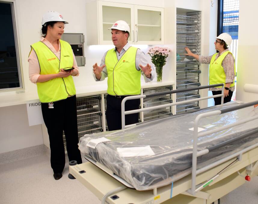 REDEVELOPMENT FUNDING: Margo Mackenzie, Dugald Saunders and Debbie Bickerton check out a prototype room during a tour of the under-construction Macquarie Building. Photo: BELINDA SOOLE