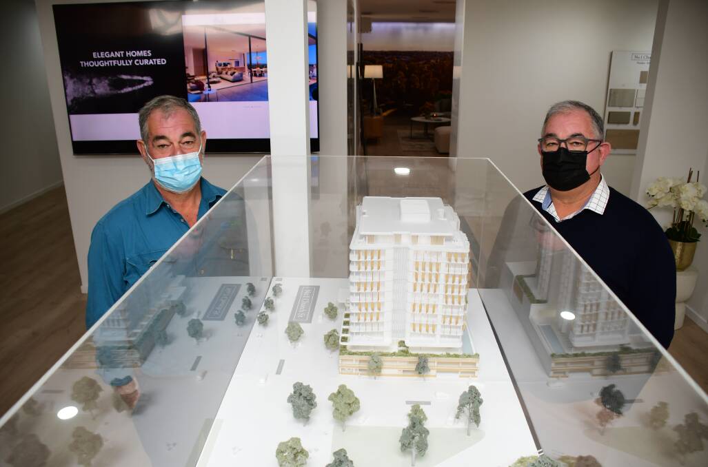 Co-developers of No.1 Church Street with Australian business icon Gerry Harvey, Kevin and John Walkom point out the model of the 13-storey apartment block at a new marketing suite in Macquarie Street. Photo: BELINDA SOOLE.