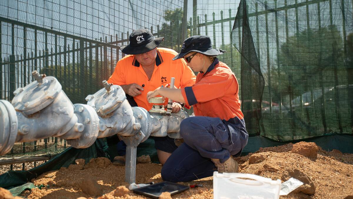 JOB DONE: Dubbo Regional Council staff install a smart water meter at a council facility. Photo: Contributed.