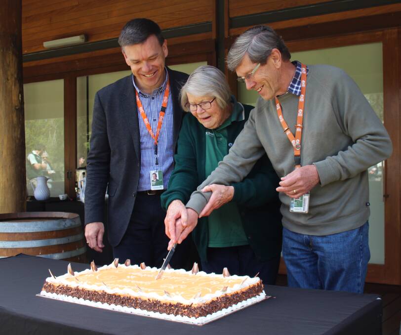 ANNIVERSARY CAKE: Matthew Fuller watches as  Patsy Forrester and Bob Barden cut the cake at the 30th anniversary morning tea. Photo: Contributed