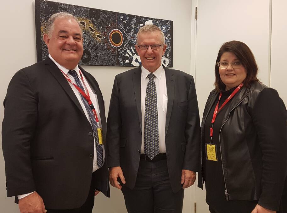 PROJECT FUNDING: Regional Development Australia Orana chairman John Walkom (left) and director Megan Dixon discuss The Welcome Project with federal Member for Parkes Mark Coulton. Photo: Contributed