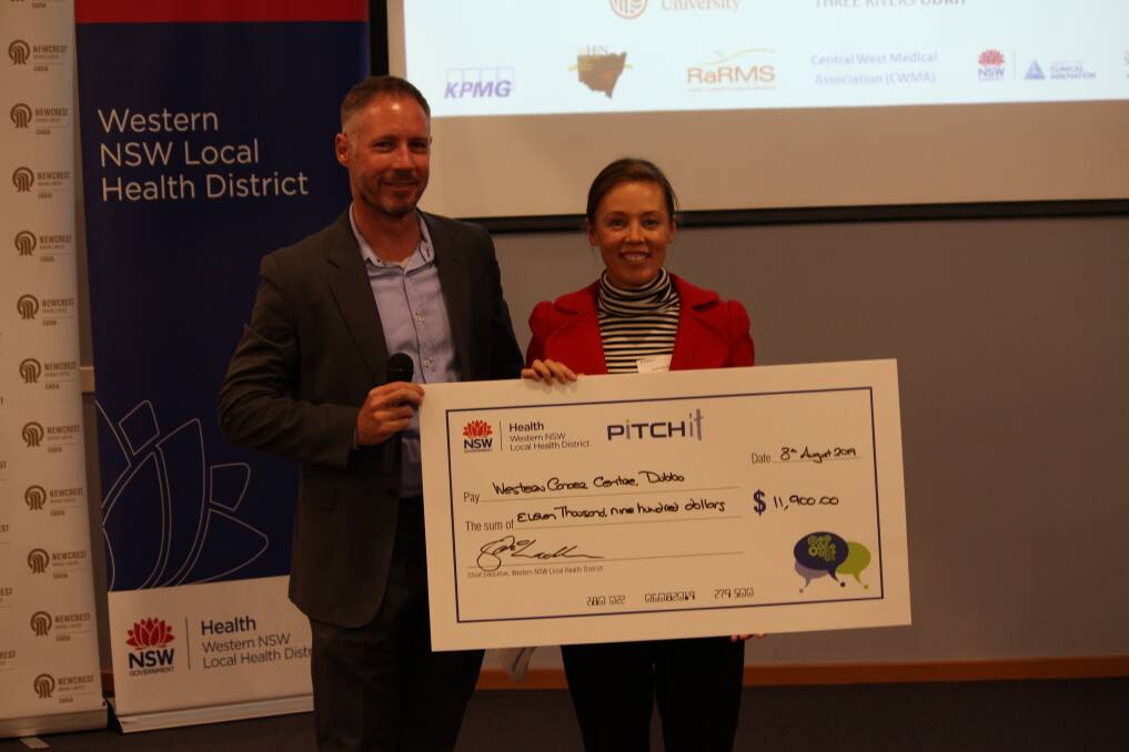 The Western NSW Local Health District's chief executive Scott McLachlan presents Belinda Berryman with a cheque for $11,900 for the Western Cancer Centre Dubbo A Virtual Tour at the PITCHit event. Photo: Contributed