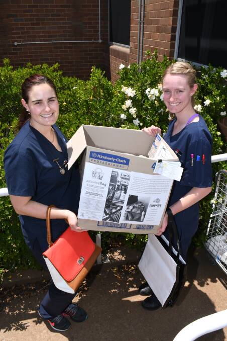 DONATIONS: Dubbo Hospital Emergency Department registered nurses Jody Cunningham and Emilie Taylor hold the box in which donations to the latest Share the Dignity appeal will be stored. Photo: BELINDA SOOLE
